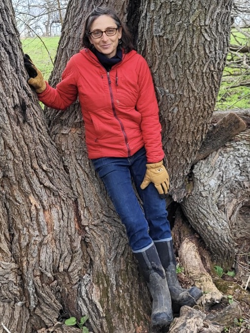 Author Beth Hoffman standing next to tree
